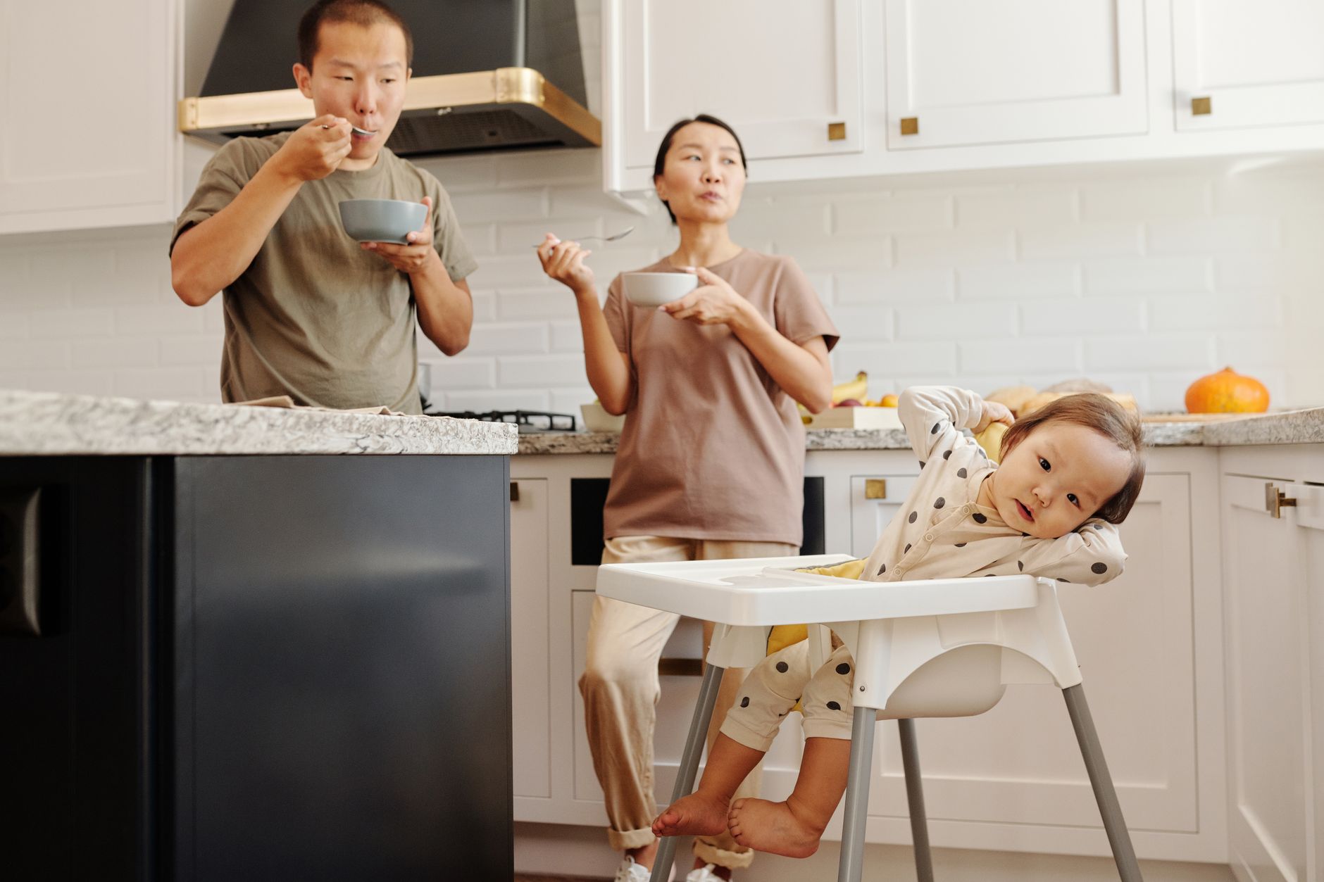 Family sharing breakfast in a kitchen as part of a daily routine
